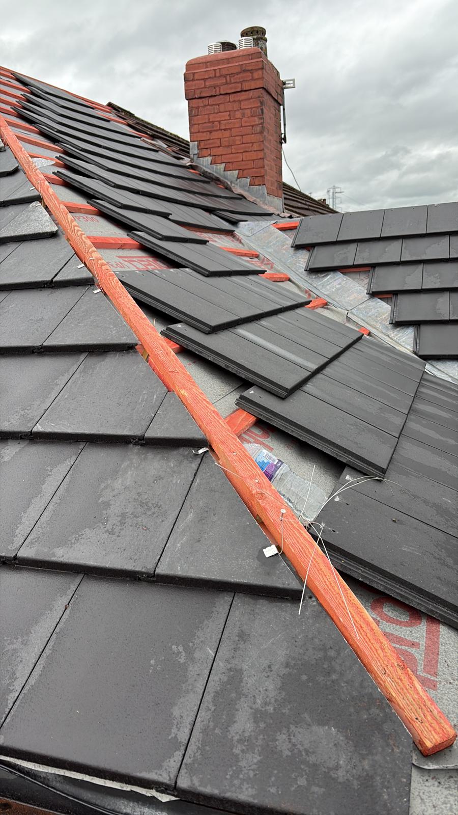 Tiles laid course by course above a fascia and soffit line