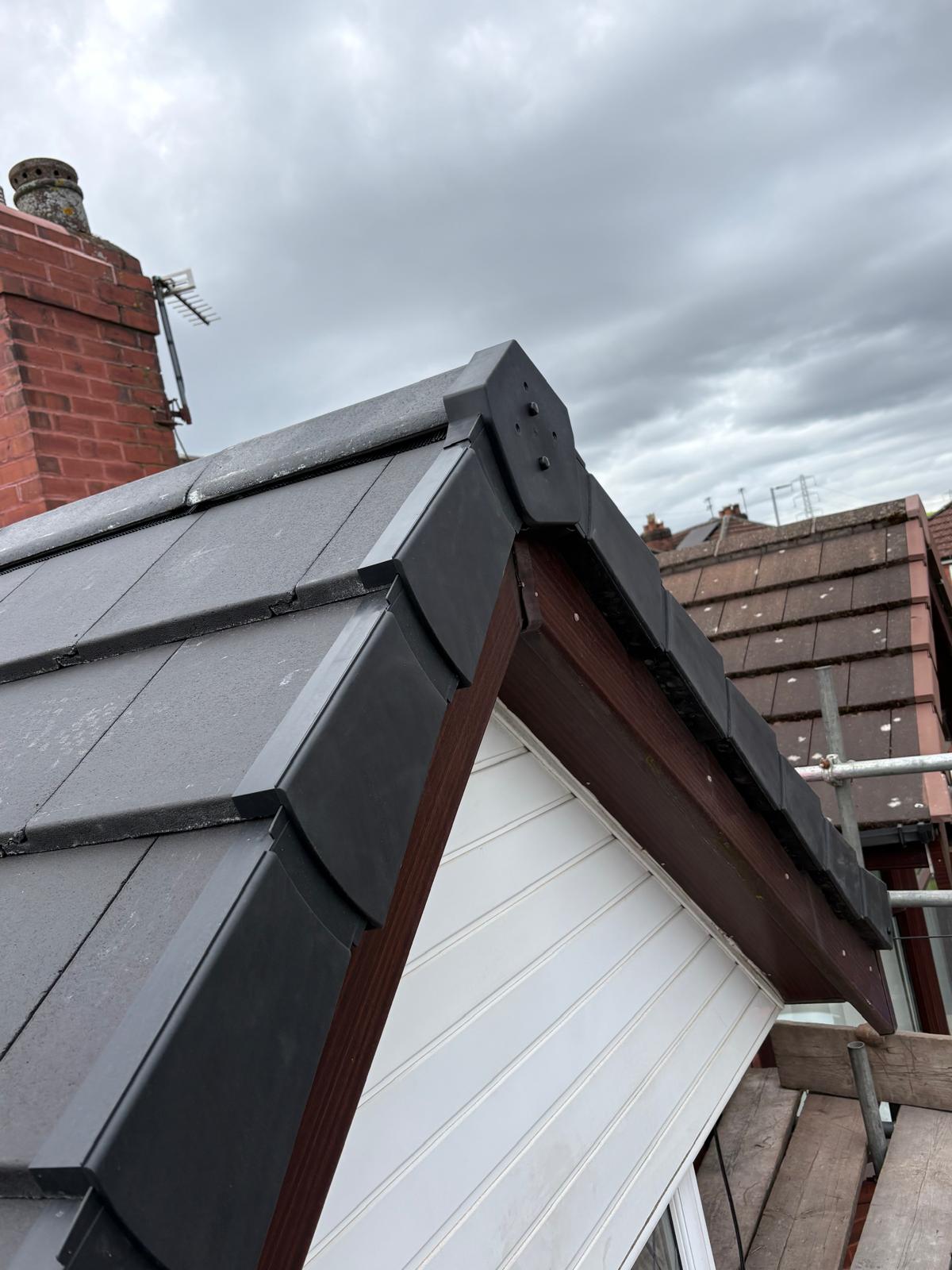 A dry verge and bargeboard along a tiled roof edge