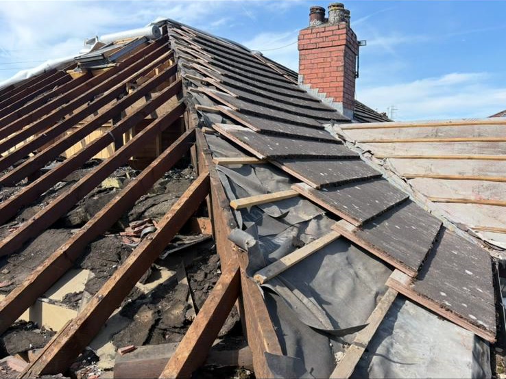 A conservatory roof stripped back to its rafters